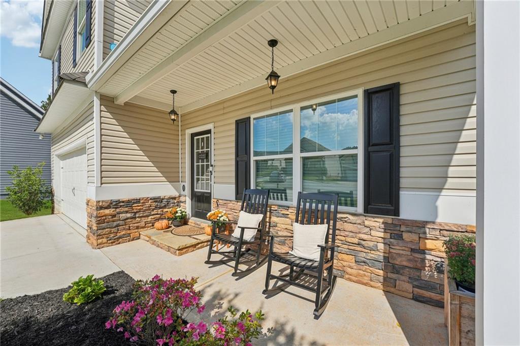 621 Stonehurst Lane Canton, GA 30114 - Photo 4 of 62 a roof deck with table and chairs and potted plants