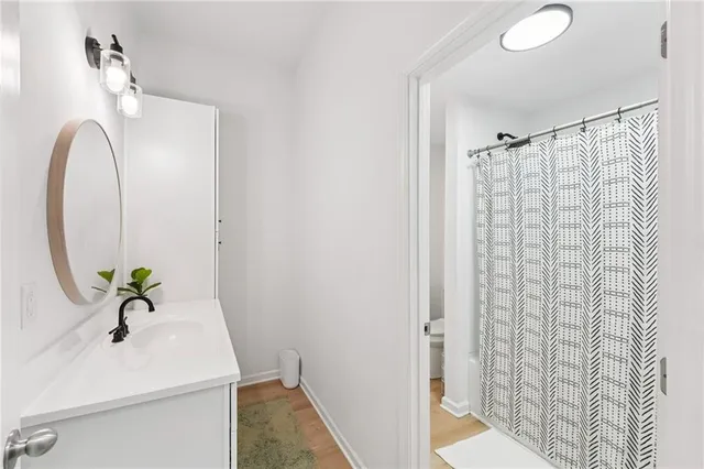 a view of a house with a small yard and a large tree