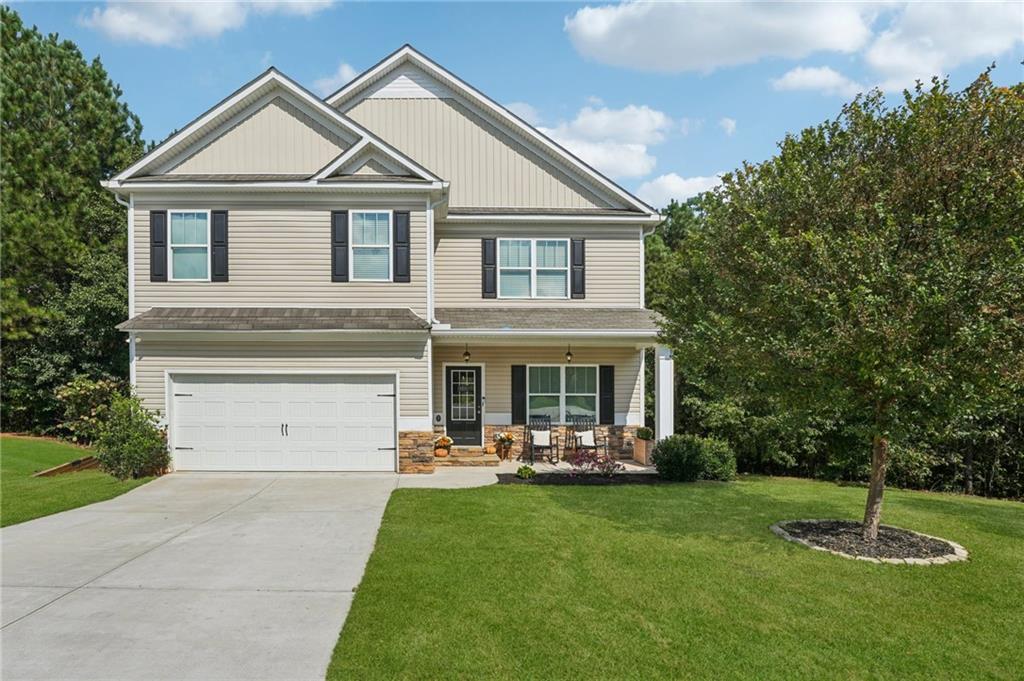 621 Stonehurst Lane Canton, GA 30114 - Photo 58 of 62 a front view of a house with a yard and trees