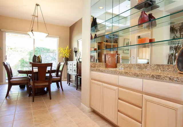 a dining table with chairs and window