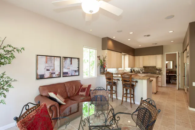 a living room with lots of furniture and kitchen view