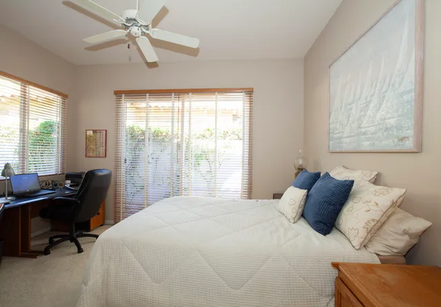 a bedroom with a bed and a desk