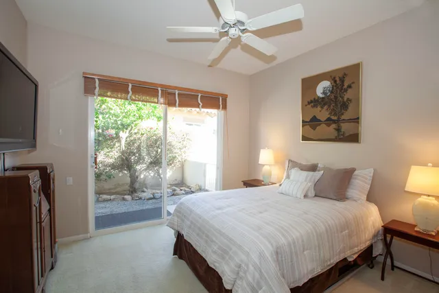 a bedroom with a large bed and a tv