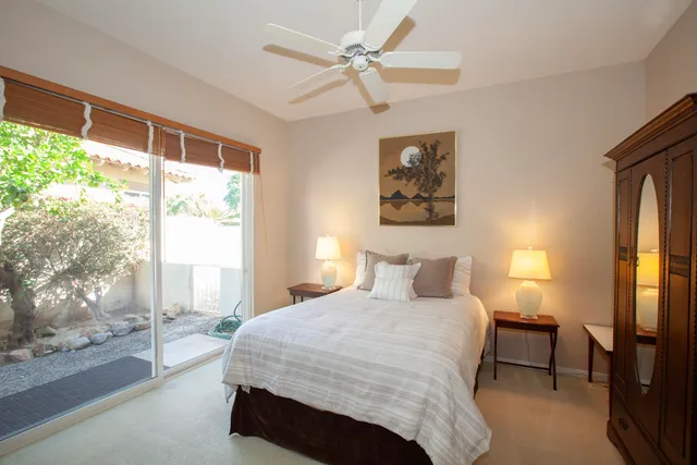 a bedroom with a large bed and a window