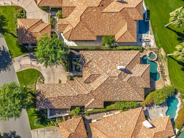 an aerial view of a house with a yard and lake view