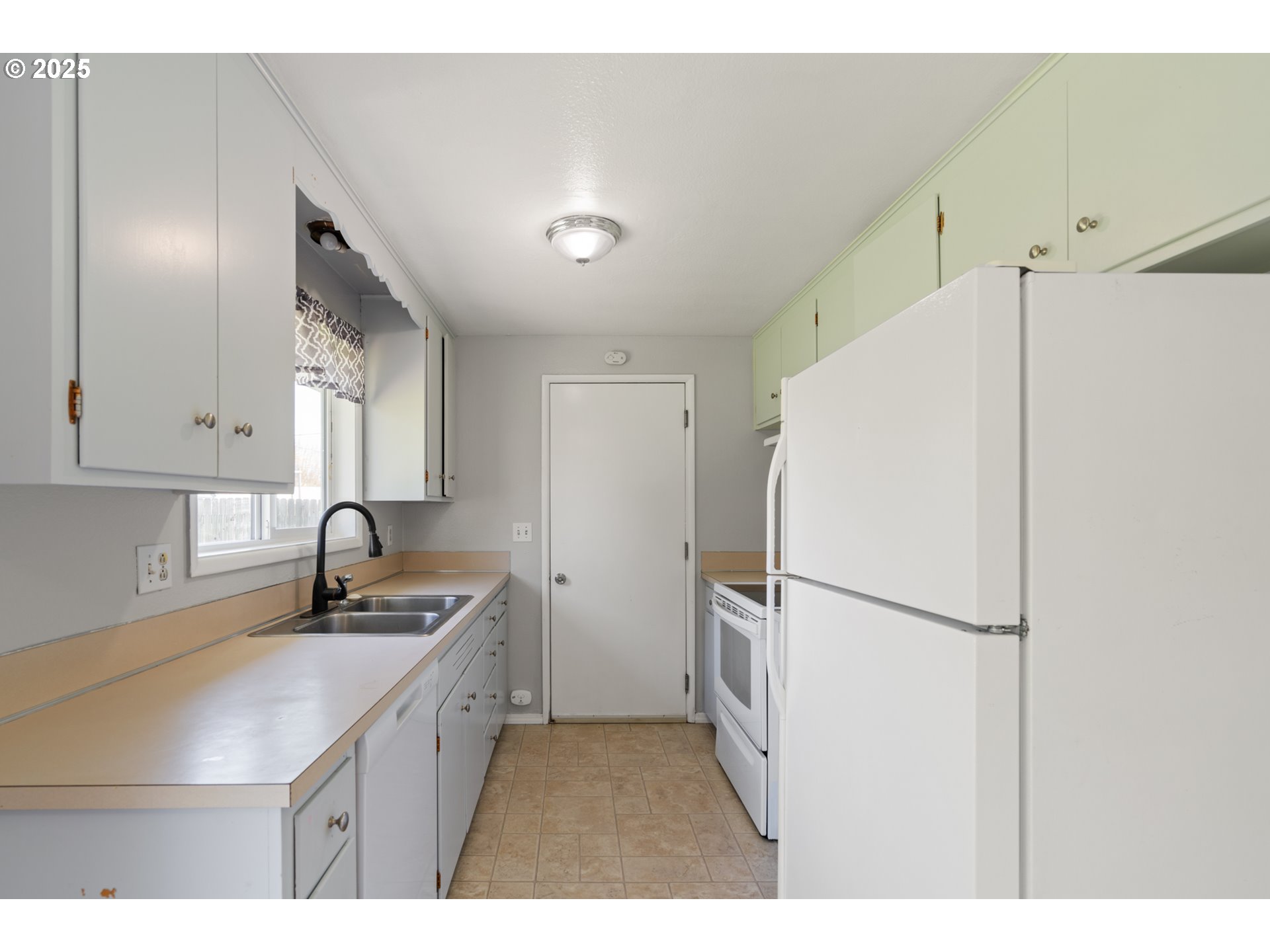 1855 Alderwood Street Eugene, OR 97404 - Photo 11 of 31 a kitchen with refrigerator cabinets and a sink