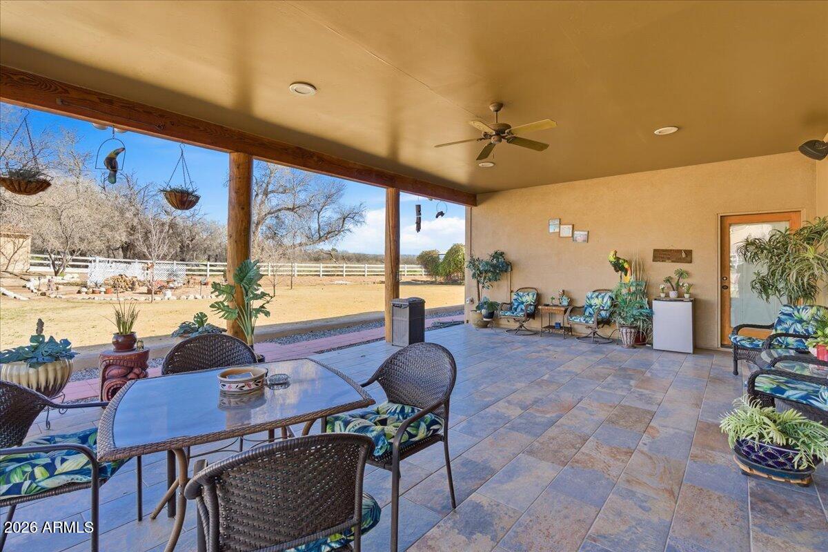 4605 Caughran Road Camp Verde, AZ 86322 - Photo 13 of 34 a view of a dining room with furniture large windows and wooden floor