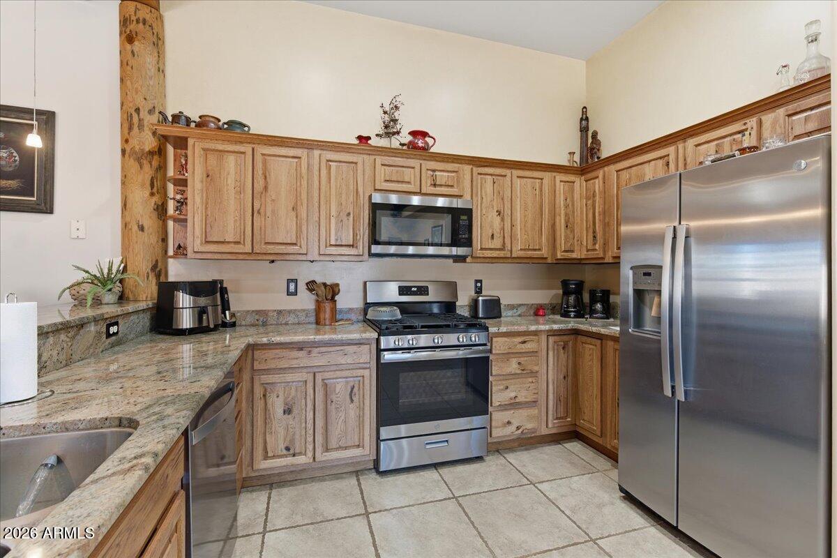 4605 Caughran Road Camp Verde, AZ 86322 - Photo 22 of 34 a kitchen with stainless steel appliances granite countertop a stove top oven a sink and a refrigerator