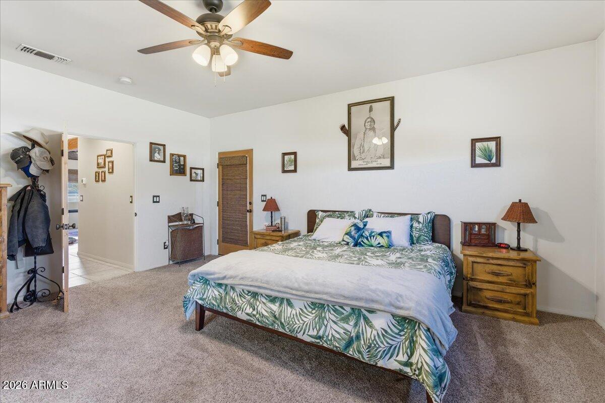 4605 Caughran Road Camp Verde, AZ 86322 - Photo 26 of 34 a bedroom with a bed and a chandelier