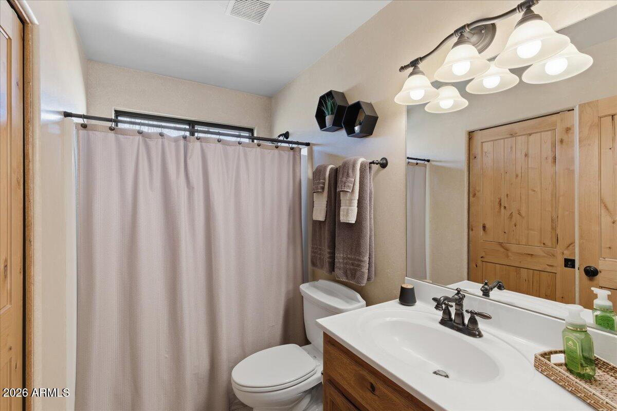 4605 Caughran Road Camp Verde, AZ 86322 - Photo 31 of 34 a bathroom with a sink vanity mirror and toilet