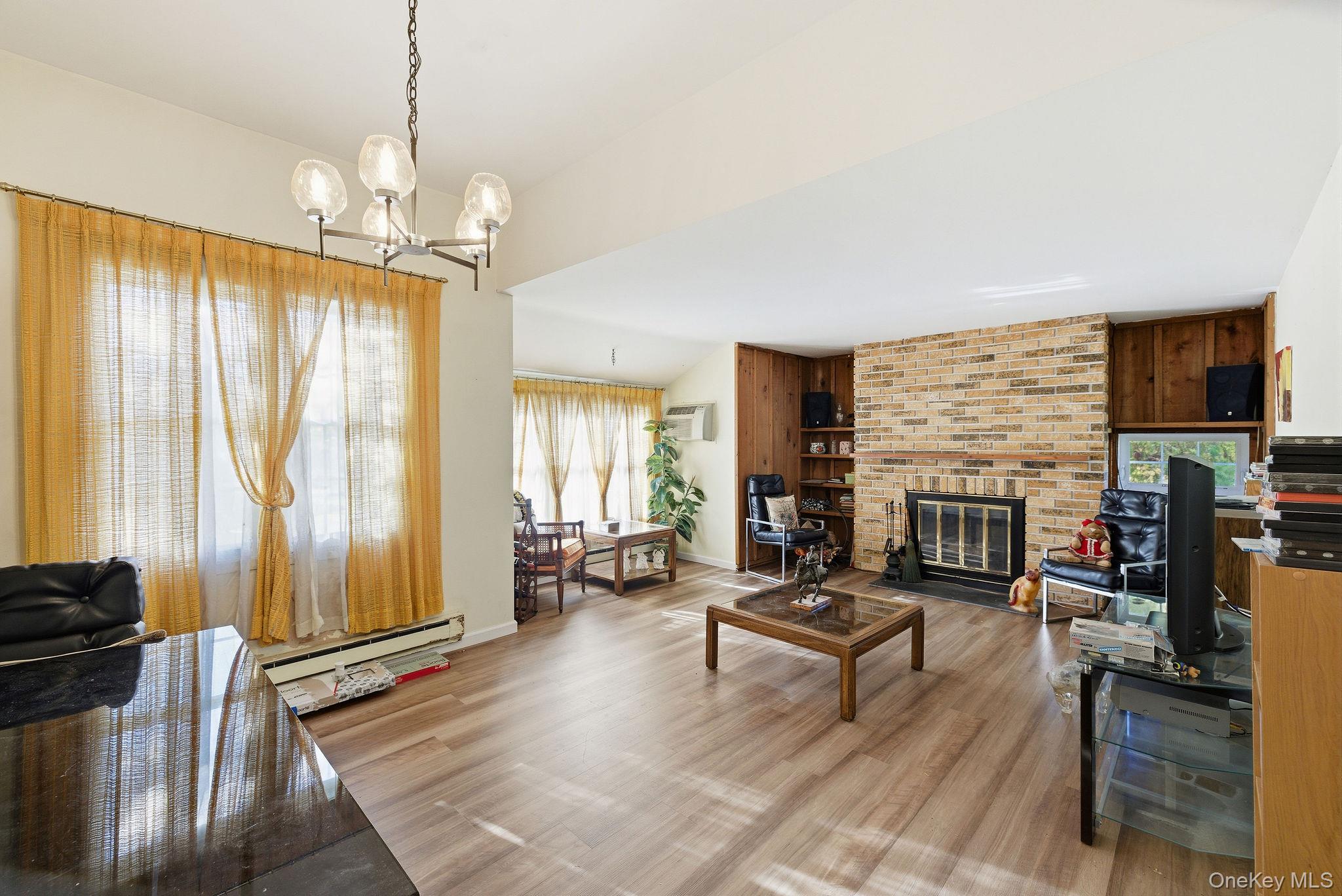 602 Holly Stream Court Brewster, NY 10509 - Photo 11 of 19 a living room with fireplace furniture and a flat screen tv