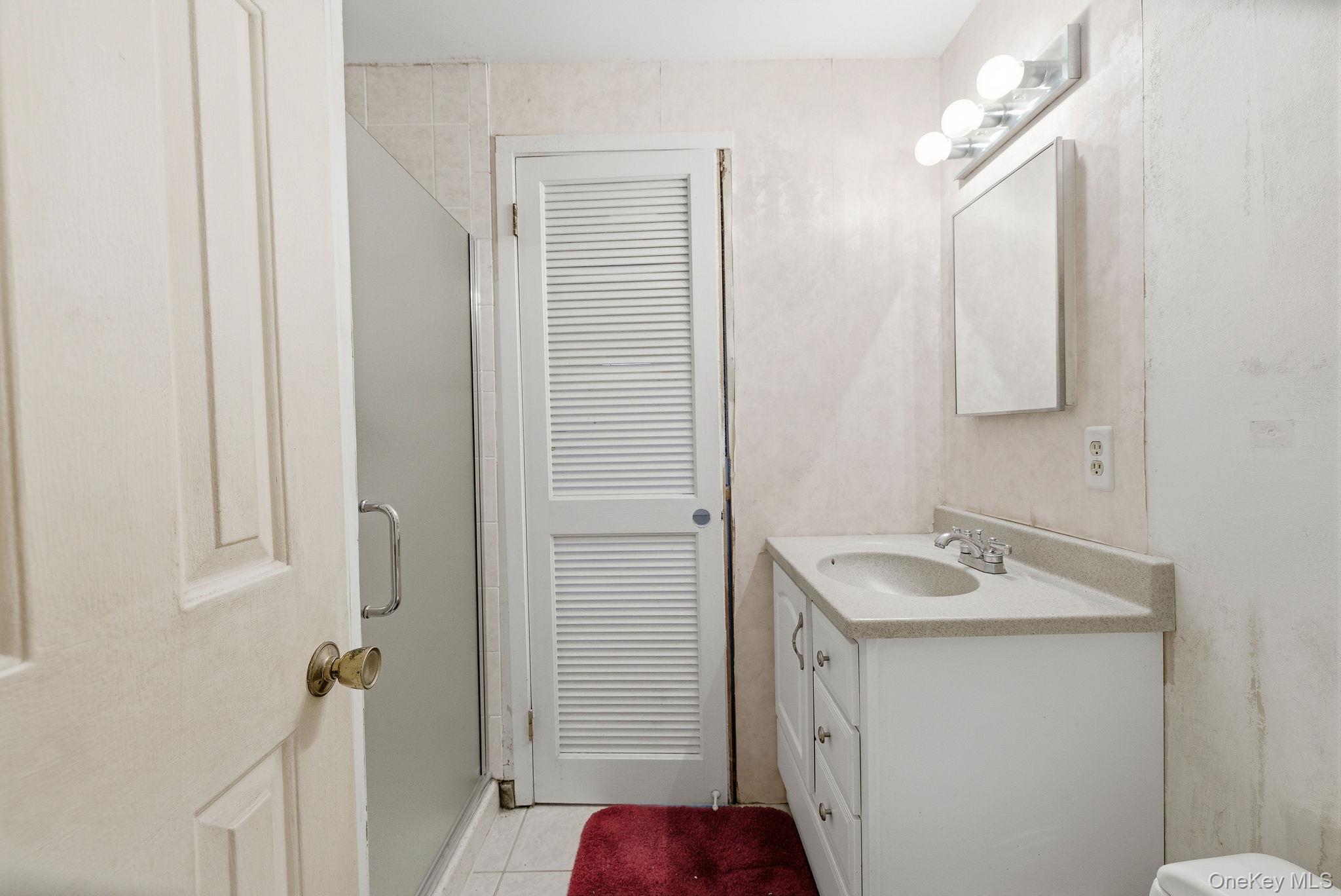 602 Holly Stream Court Brewster, NY 10509 - Photo 15 of 19 a bathroom with a sink and a mirror