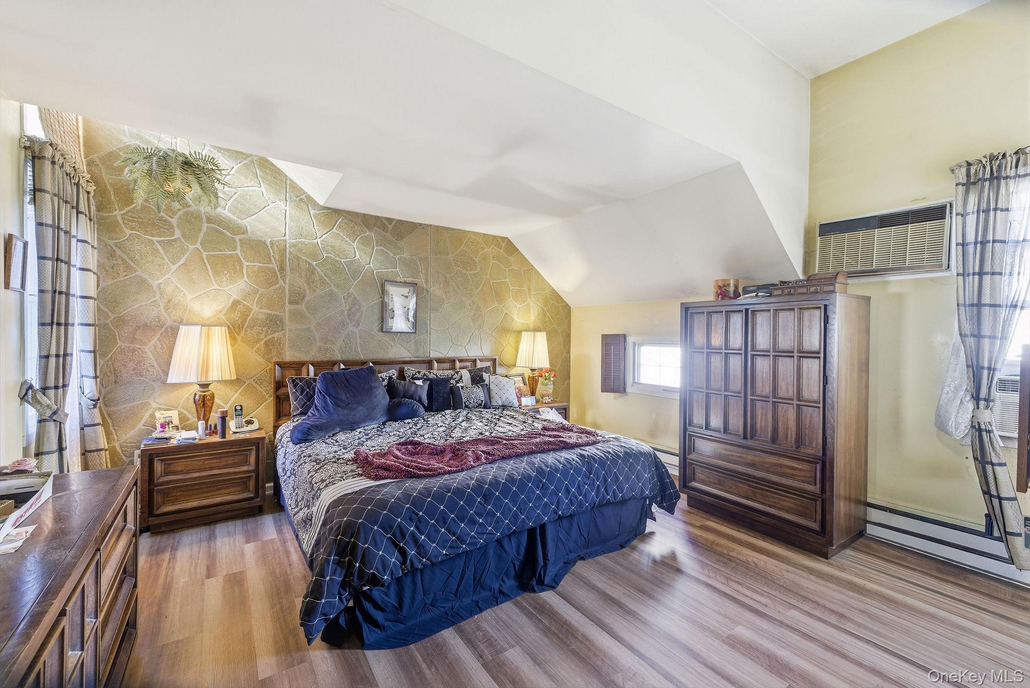 602 Holly Stream Court Brewster, NY 10509 - Photo 16 of 19 a bedroom with a large bed and a chandelier