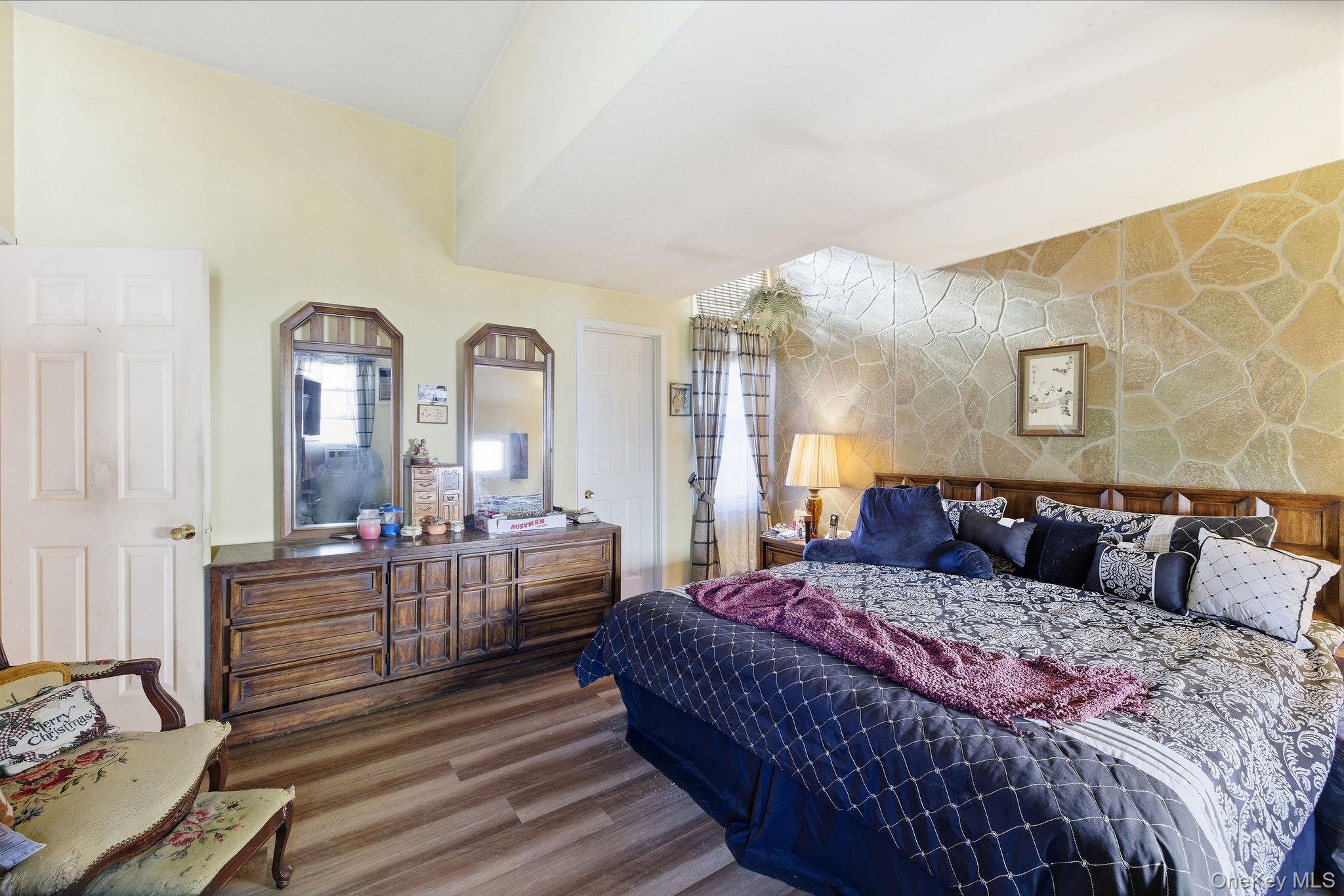 602 Holly Stream Court Brewster, NY 10509 - Photo 17 of 19 a bedroom with a bed and wooden floor