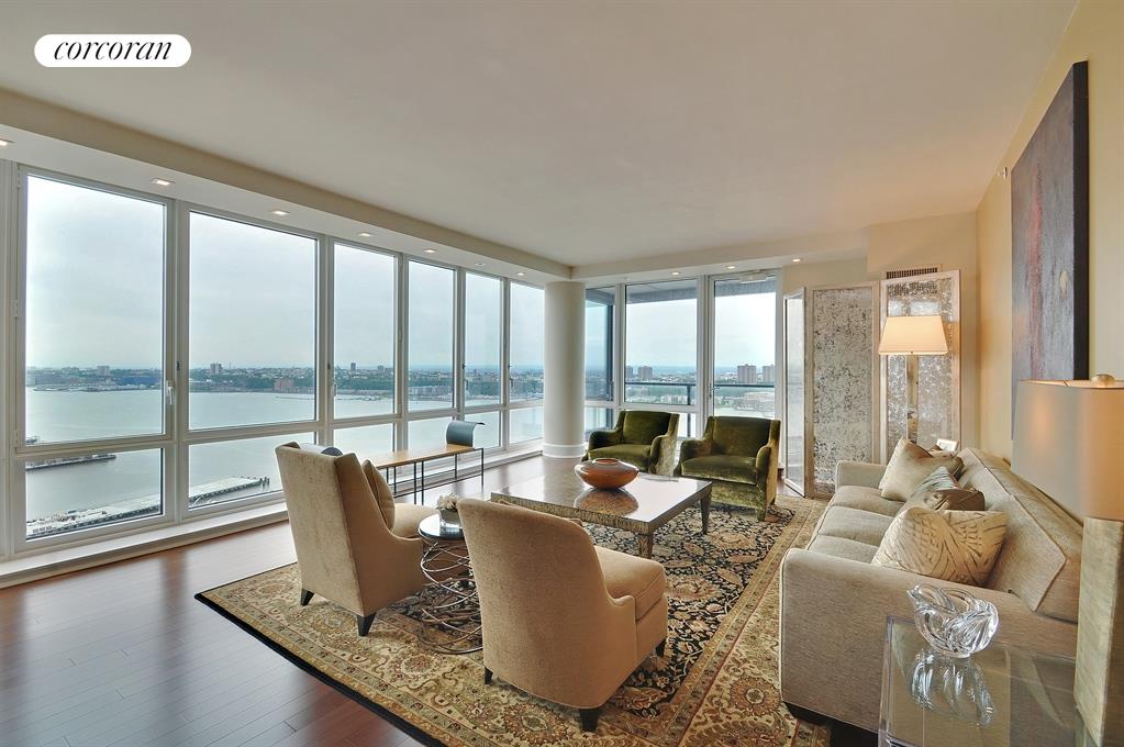 60 Riverside Boulevard, Unit 3403 Manhattan, NY 10069 - Photo 1 of 1 a living room with furniture and floor to ceiling windows