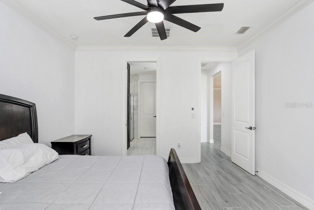 11677 Brighton Knoll Loop Riverview, FL 33579 - Photo 13 of 30 a bedroom with a bed and a ceiling fan