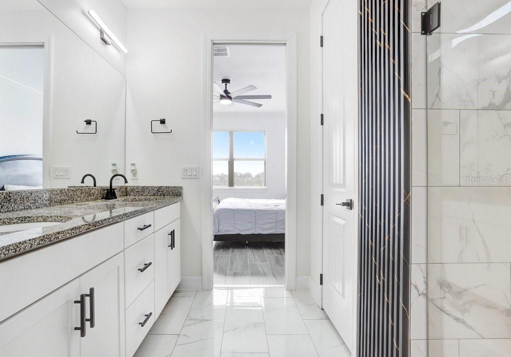 11677 Brighton Knoll Loop Riverview, FL 33579 - Photo 15 of 30 a bathroom with a granite countertop sink a mirror and a