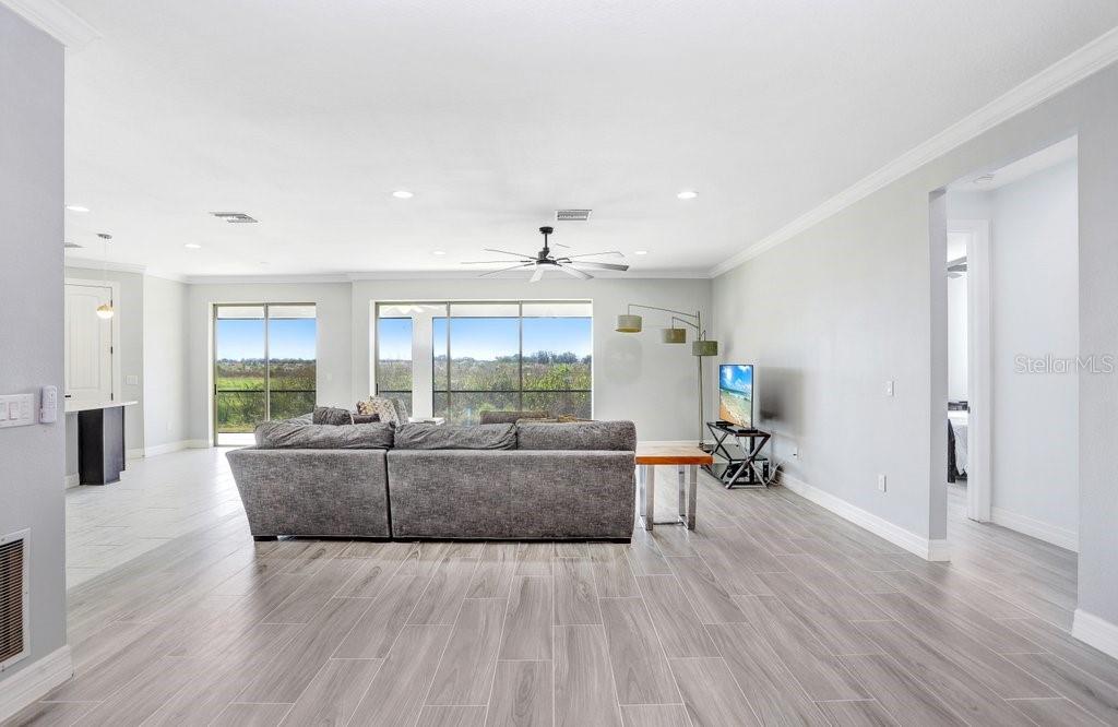 11677 Brighton Knoll Loop Riverview, FL 33579 - Photo 16 of 30 a living room with furniture and a wooden floor