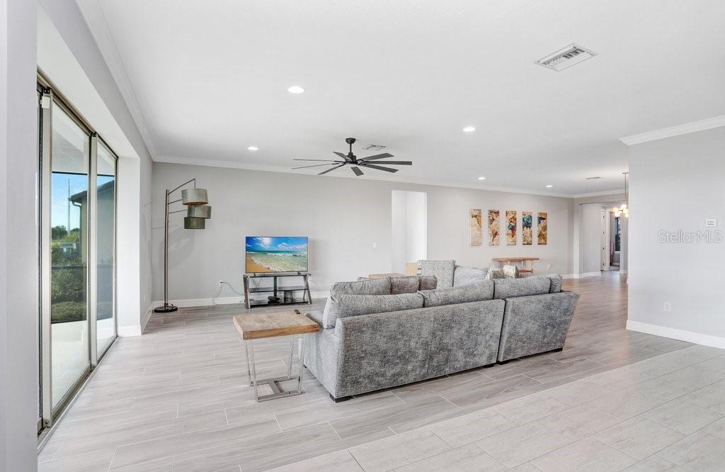 11677 Brighton Knoll Loop Riverview, FL 33579 - Photo 19 of 30 a living room with furniture and a ceiling fan