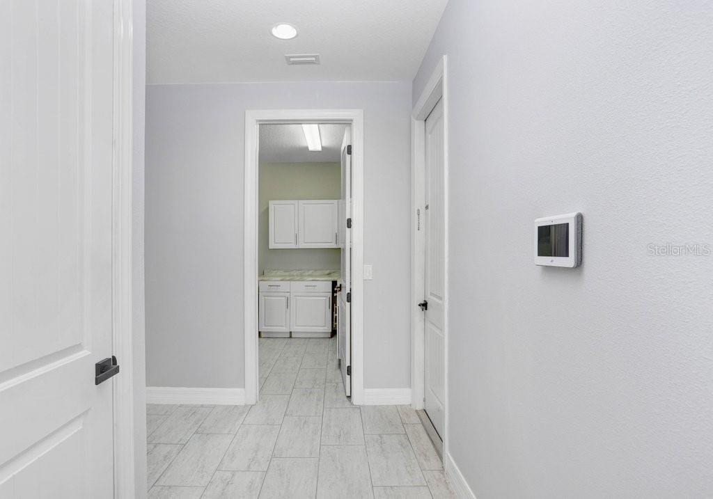 11677 Brighton Knoll Loop Riverview, FL 33579 - Photo 24 of 30 a view of a hallway with a room space and a bathroom