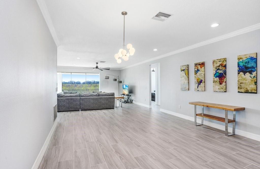 11677 Brighton Knoll Loop Riverview, FL 33579 - Photo 5 of 30 a living room with furniture and a chandelier