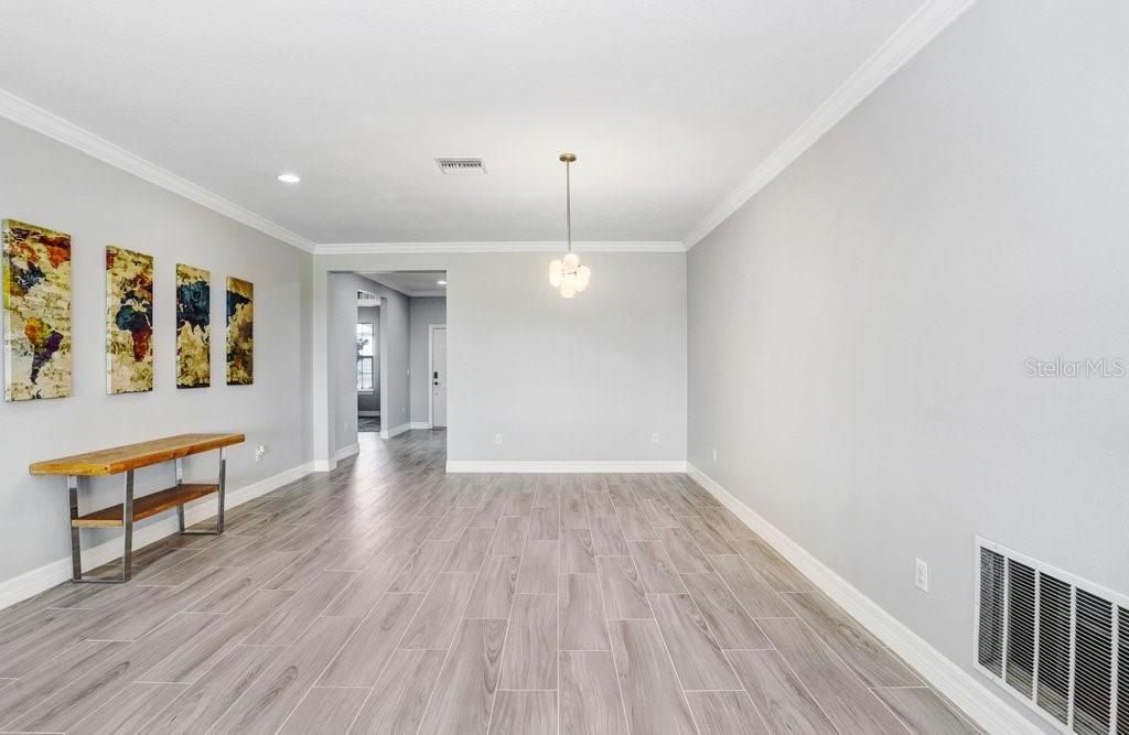 11677 Brighton Knoll Loop Riverview, FL 33579 - Photo 6 of 30 a view of an empty room with window and wooden floor