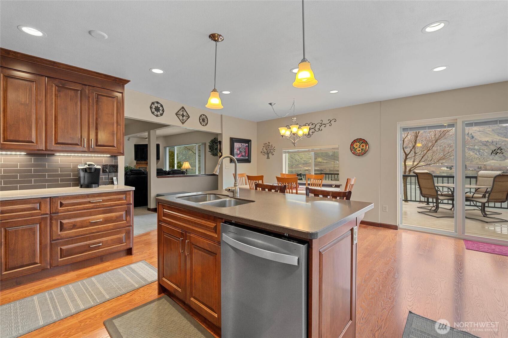 2548 Entiat Way Entiat, WA 98822 - Photo 13 of 40 a kitchen with stainless steel appliances granite countertop a sink a stove and a wooden floors