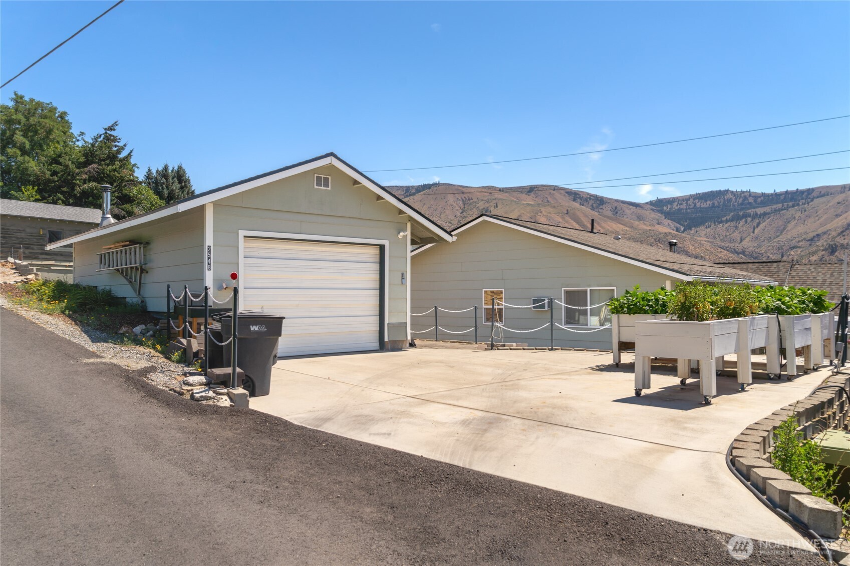 2548 Entiat Way Entiat, WA 98822 - Photo 29 of 40 a view of a patio with a table and chairs under an umbrella
