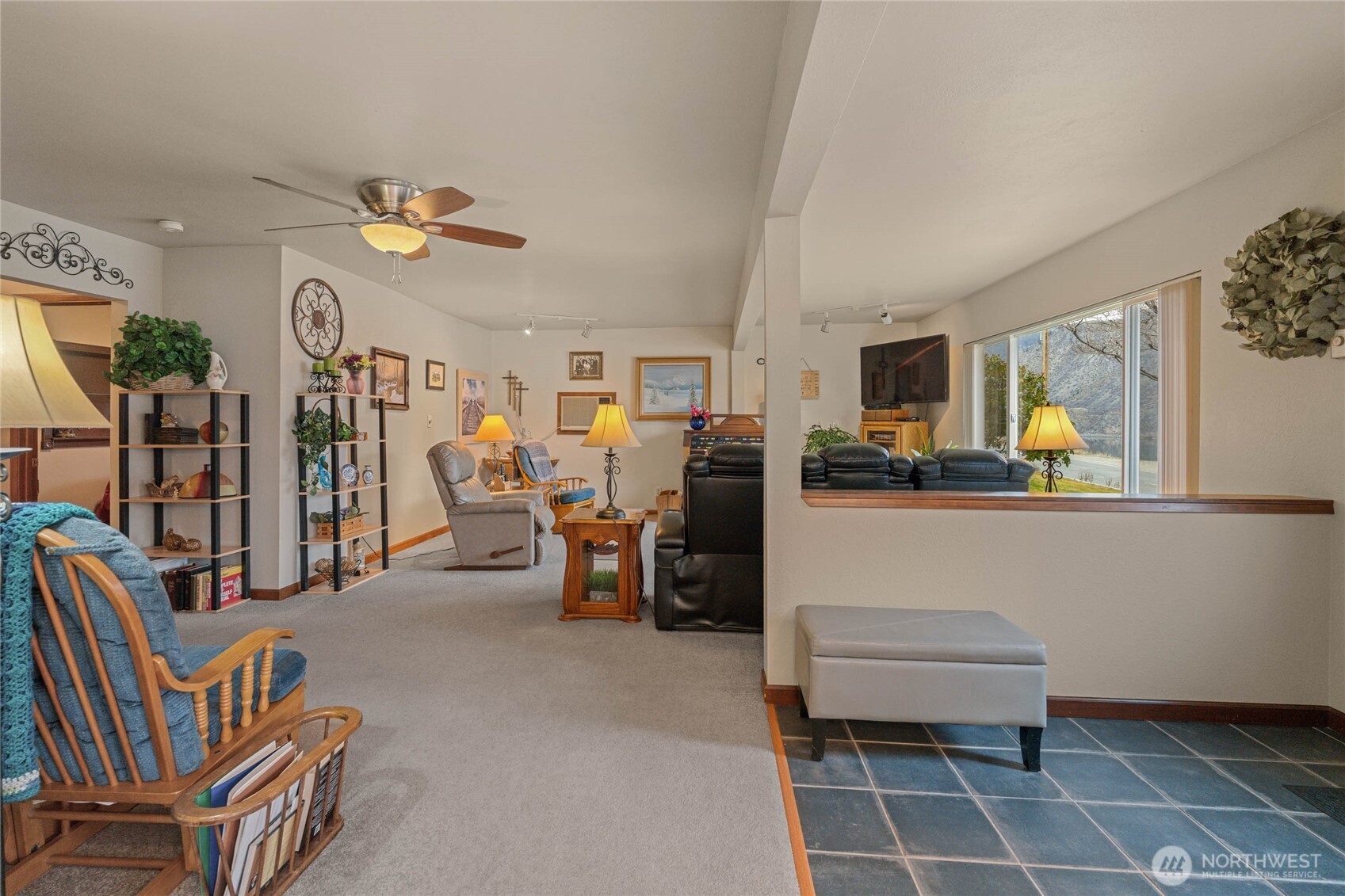 2548 Entiat Way Entiat, WA 98822 - Photo 8 of 40 a living room with furniture a flat screen tv and kitchen view