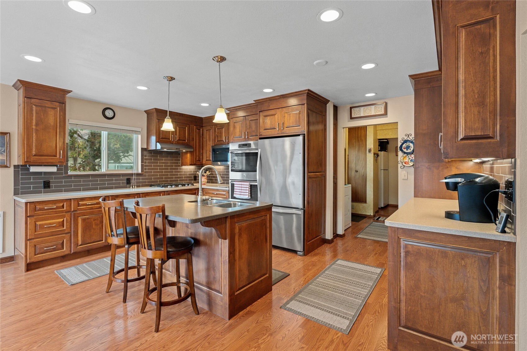 2548 Entiat Way Entiat, WA 98822 - Photo 9 of 40 a kitchen with stainless steel appliances kitchen island granite countertop a refrigerator a stove a sink a dining table and chairs