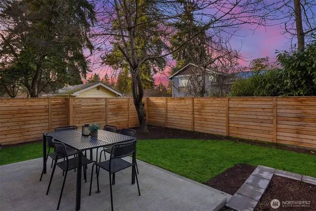 a view of backyard with seating and green space