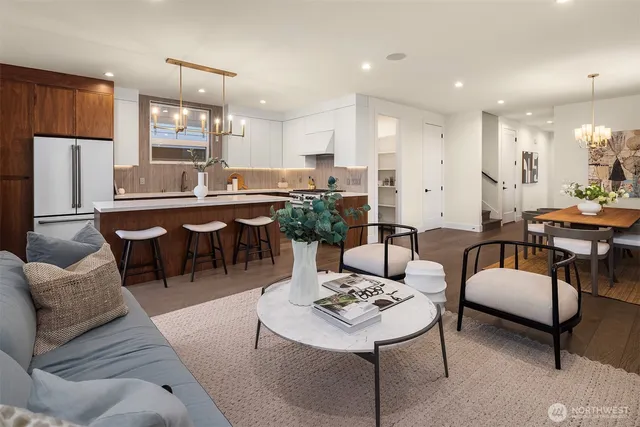 a living room with lots of furniture and view kitchen