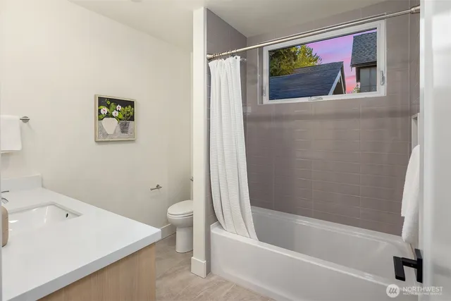 a bath room with a toilet and a bath tub