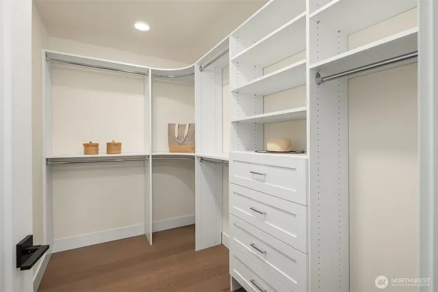 a view of walk in closet with empty racks