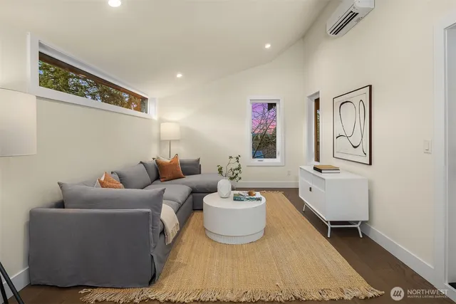 a living room with furniture and a mirror