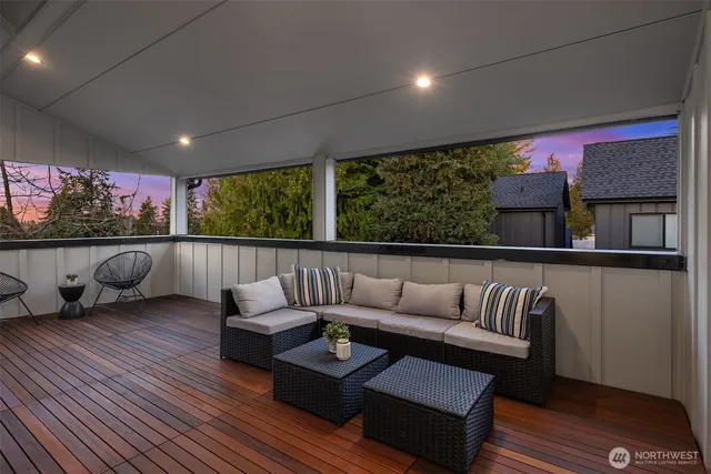 a living room with furniture and a floor to ceiling window