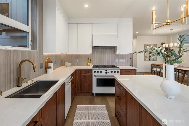 a kitchen with a sink stove and cabinets