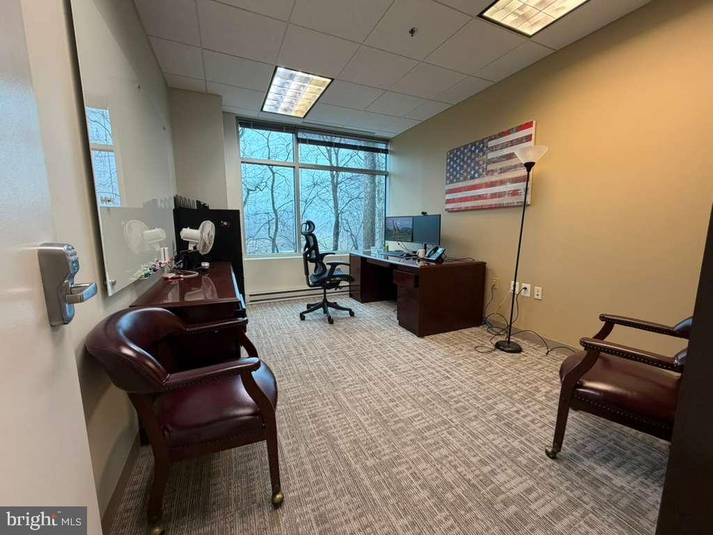 1984 Isaac Newton Square West, Unit 211 Reston, VA 20190 - Photo 2 of 9 a room with furniture and a window