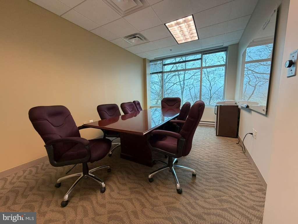 1984 Isaac Newton Square West, Unit 211 Reston, VA 20190 - Photo 7 of 9 a living room with furniture and a window