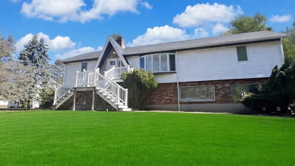 5 Flintlocke Road Franklin, MA 02038 - Photo 1 of 34 a front view of a house with a yard and green space