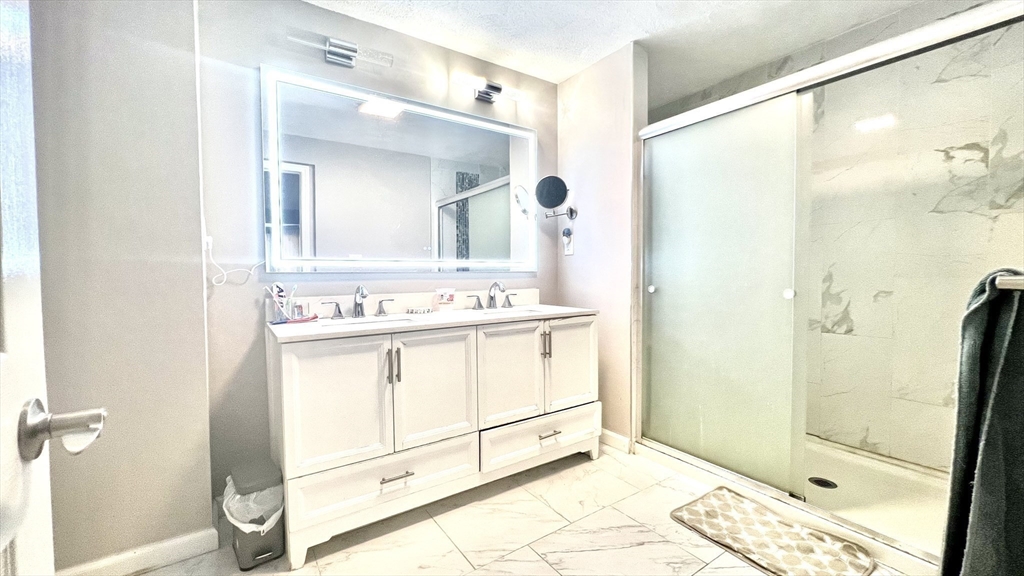 5 Flintlocke Road Franklin, MA 02038 - Photo 12 of 34 a bathroom with a tub sink vanity and mirror