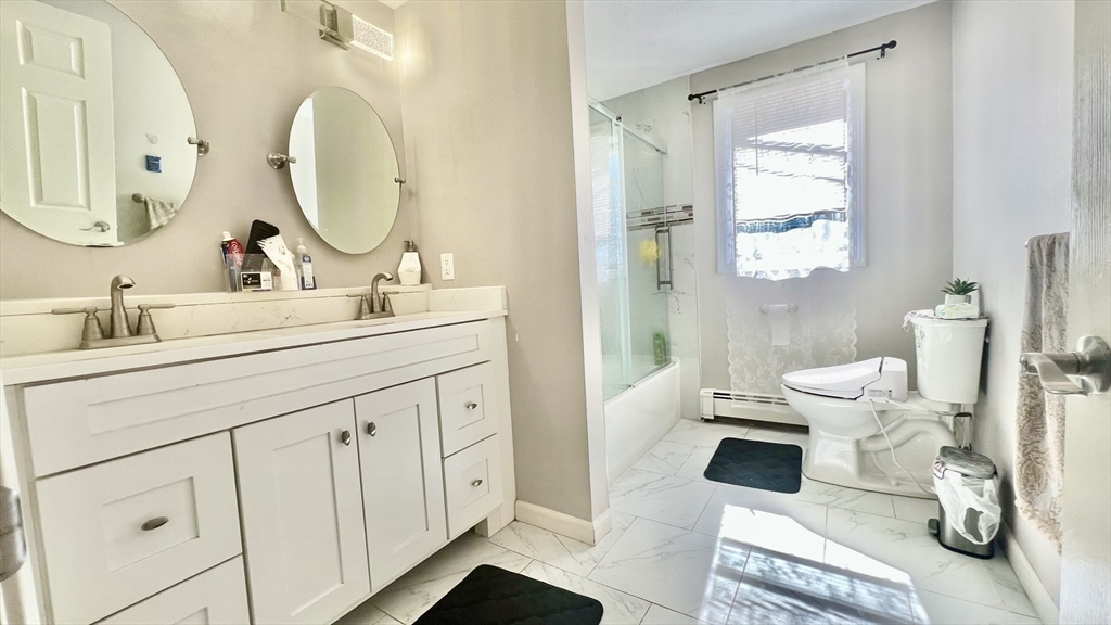 5 Flintlocke Road Franklin, MA 02038 - Photo 13 of 34 a bathroom with a toilet sink and mirror