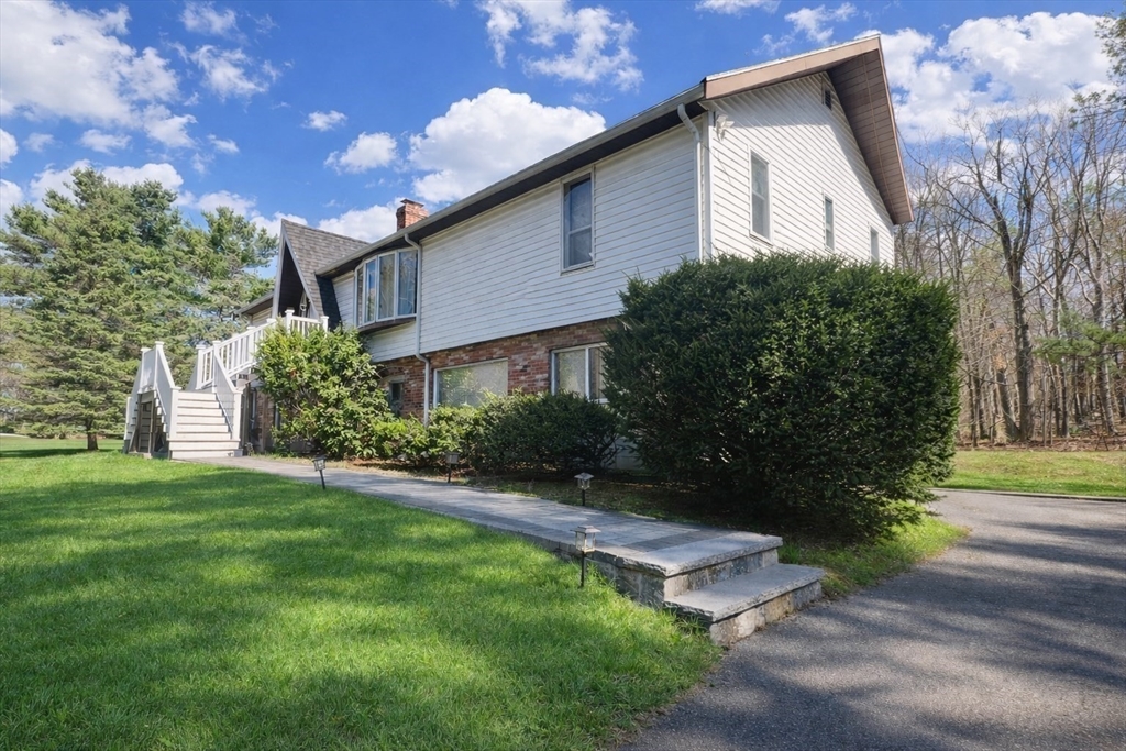 5 Flintlocke Road Franklin, MA 02038 - Photo 3 of 34 a front view of a house with garden