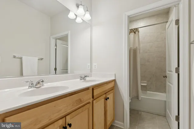 a bedroom with a bed and a ceiling fan