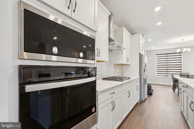 a large kitchen with kitchen island a sink a counter space and stainless steel appliances