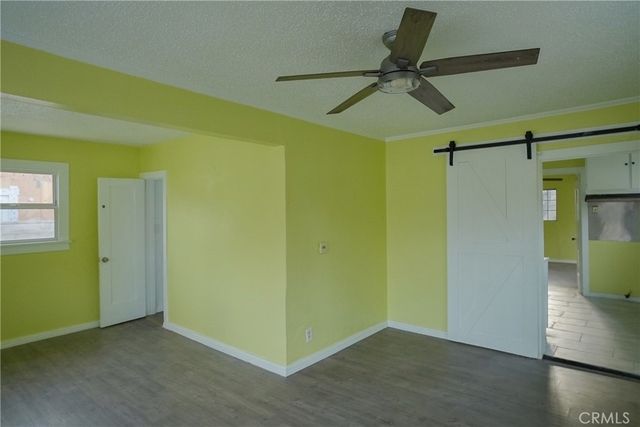 a view of a room with a window and a ceiling fan