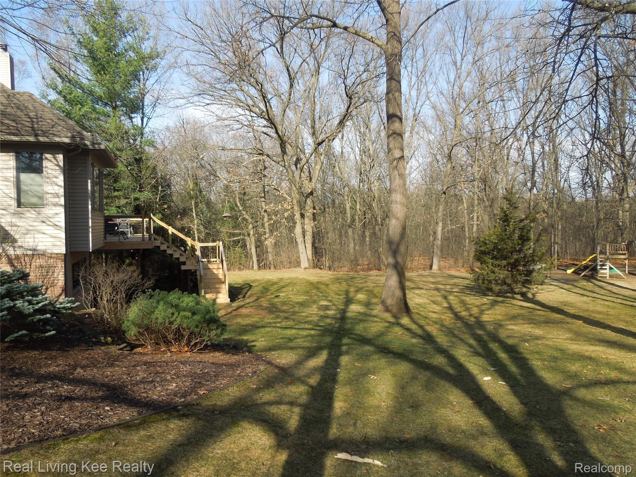 3648 Gregory Road Lake Orion, MI 48359 - Photo 7 of 68 The backyard with firepit, tire swing and play structure