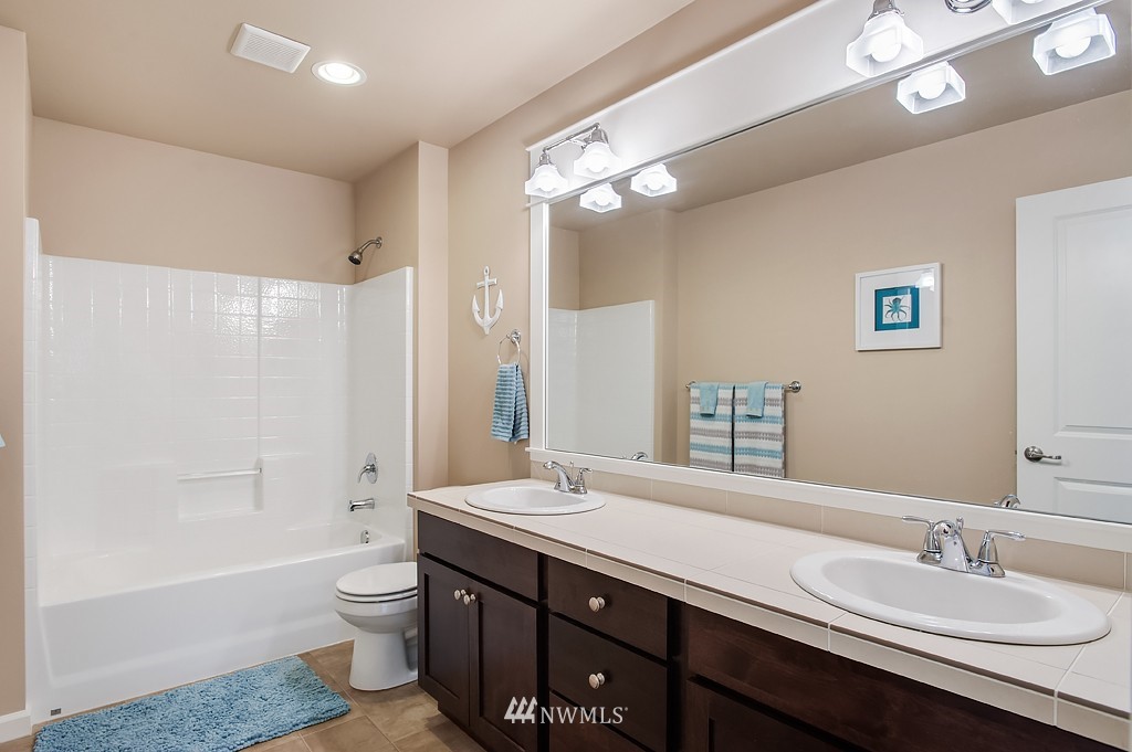 6100 Southeast 2nd Street Renton, WA 98059 - Photo 18 of 24 a bathroom with a double vanity sink toilet mirror and bathtub