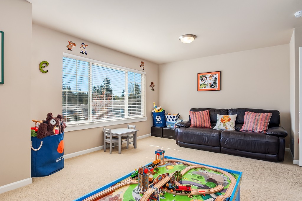 6100 Southeast 2nd Street Renton, WA 98059 - Photo 20 of 24 a living room with furniture and a book shelf