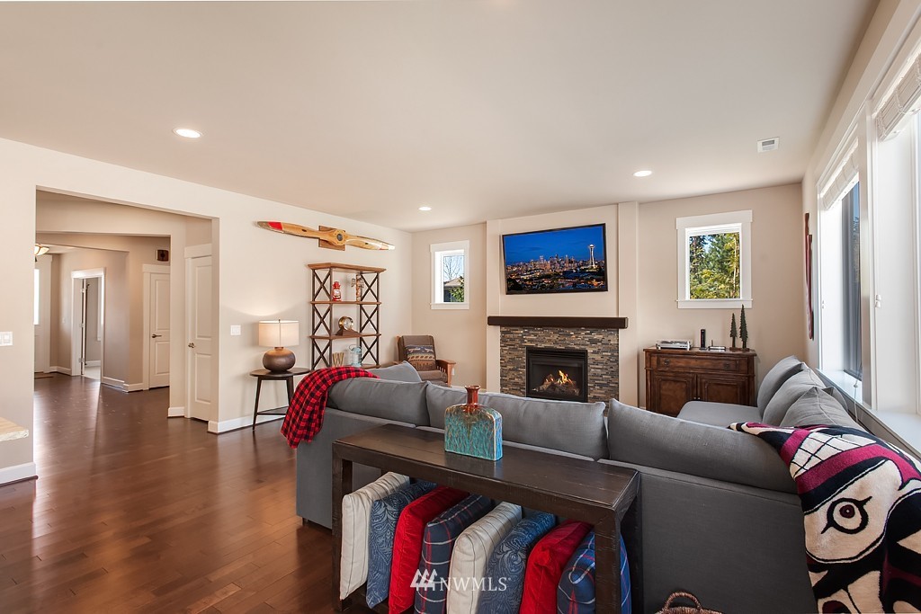 6100 Southeast 2nd Street Renton, WA 98059 - Photo 5 of 24 a living room with furniture a fireplace and a flat screen tv